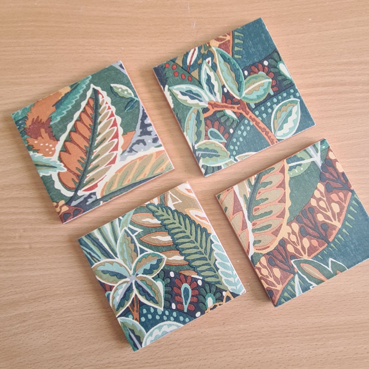 Nature's Exhibitionists ceramic coasters showing different sections of the bold botanical pattern.