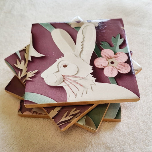 Handmade Woodland ceramic coaster featuring a hare amongst flowers and trailing foliage.