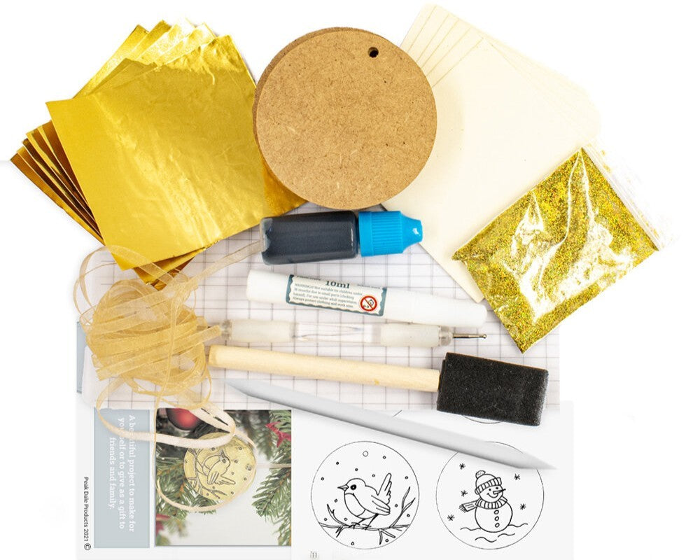 Contents of a metal embossing kit to create gold baubles from The Furniture Bureau