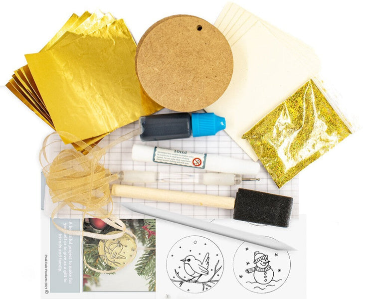 Contents of a metal embossing kit to create gold baubles from The Furniture Bureau