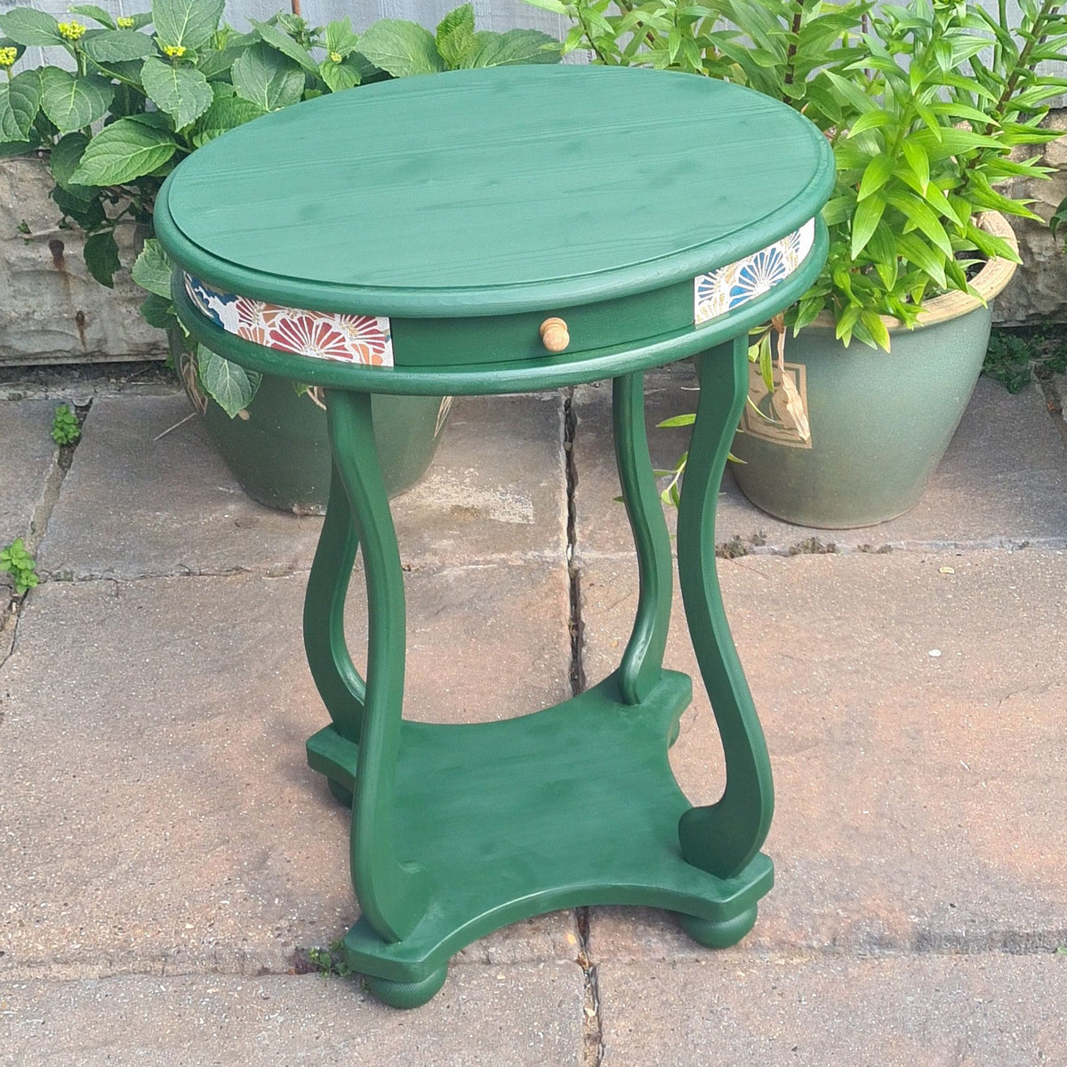 Beautifully finished furniture, created by a beginner, green side table with gold knob and wallpaper decoupaged detail, achieved at The Furniture Bureau.