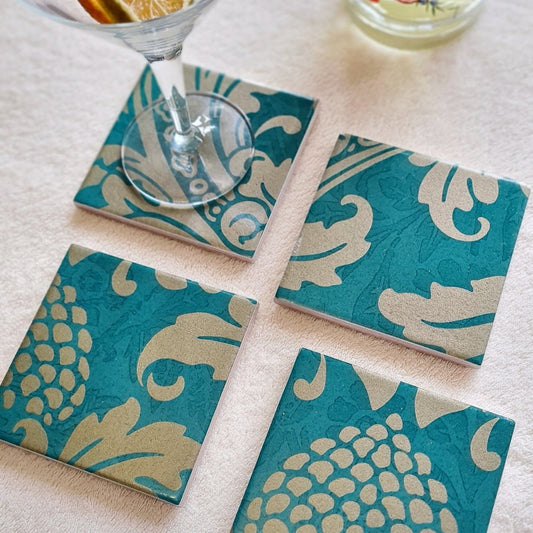 Handcrafted teal ceramic coasters decorated with an intricate Baroque-inspired design and metallic Champagne edging.  