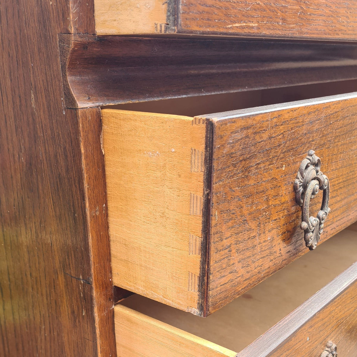 Dovetail detail on a vintage Beeanese mid-century five-drawer tallboy chest ready for a bespoke furniture transformation at The Furniture Bureau.