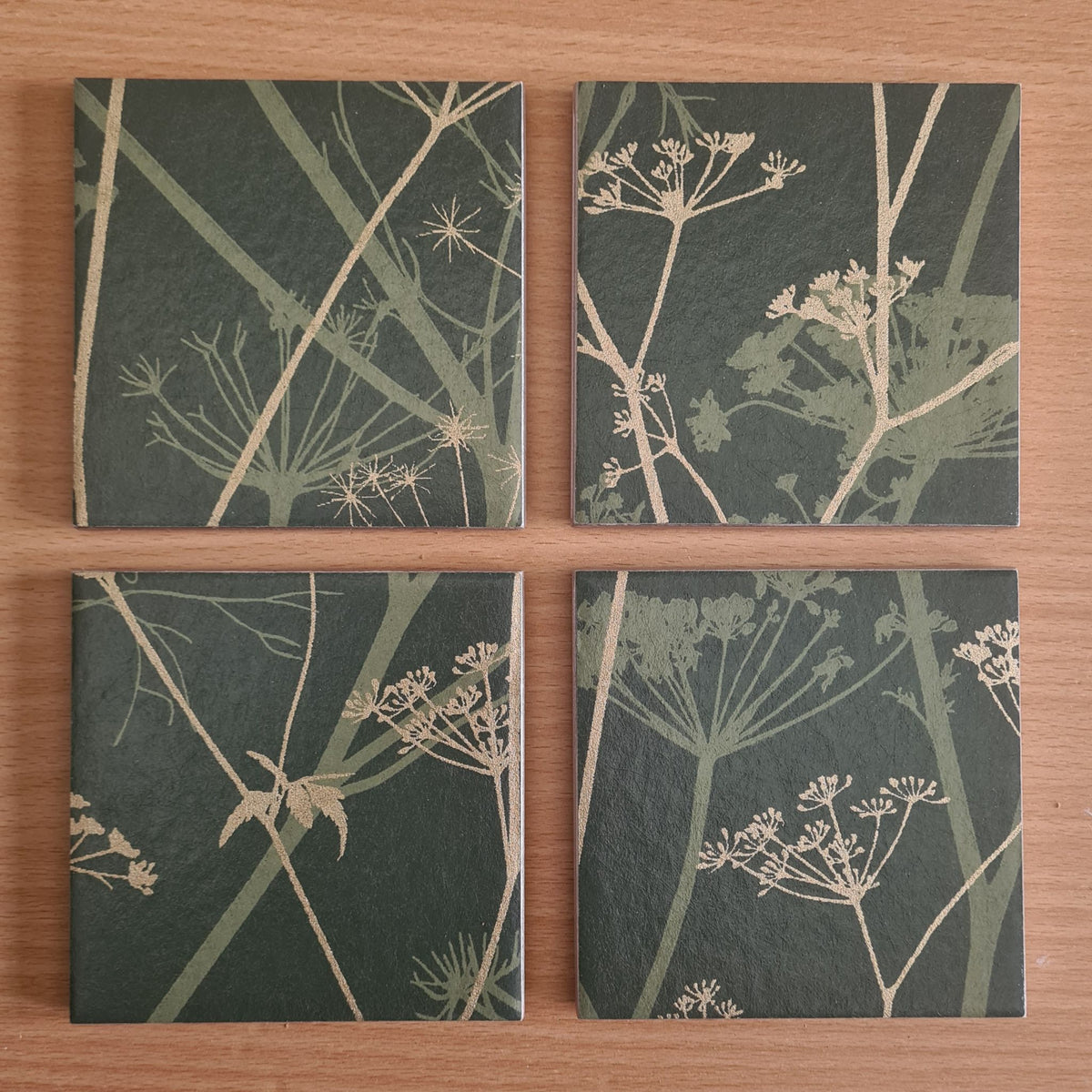 Limited-edition Wild Chervil ceramic coasters arranged to show their individual botanical pattern placement.