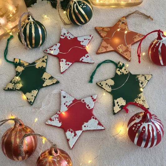 stunning ceramic stars and baubles in seasonal colours with metallic leaf accents, created by hand by The Furniture Bureau
