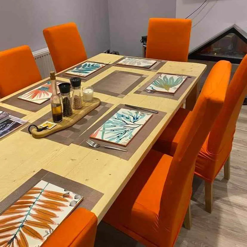 Customer's dining table set with rectangular custom made place mats, using their Yasumi wallpaper, by The Furniture Bureau.