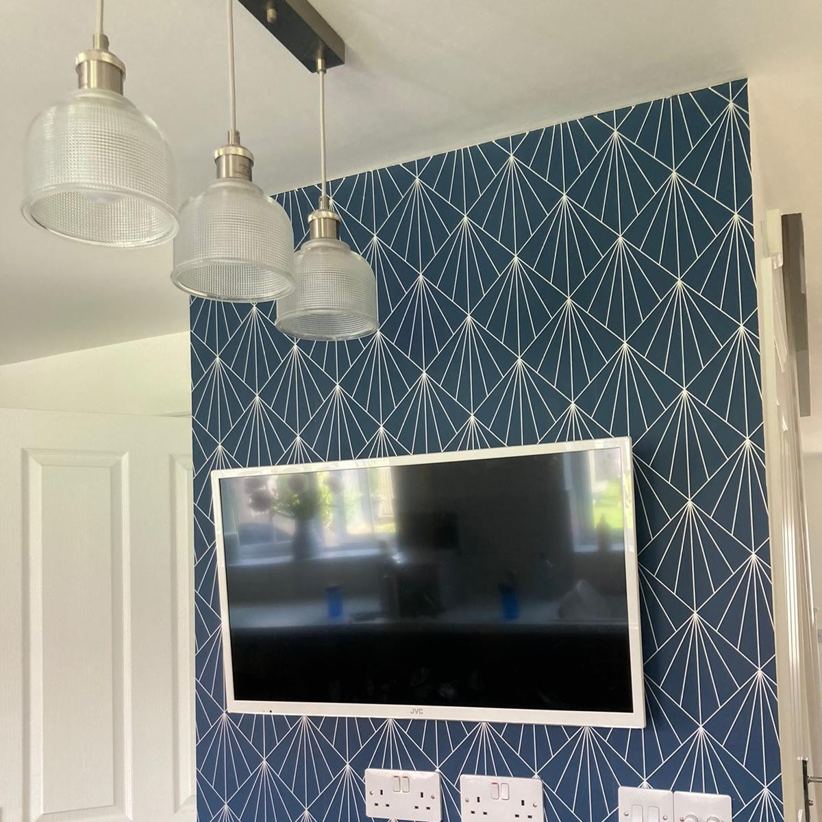 My customer's dining room wall showing her geometric wallpaper used to create custom place mats and coasters.