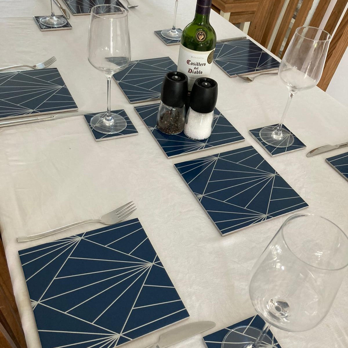 My client's dining table showing her geometric wallpaper custom-made place mats and coasters.