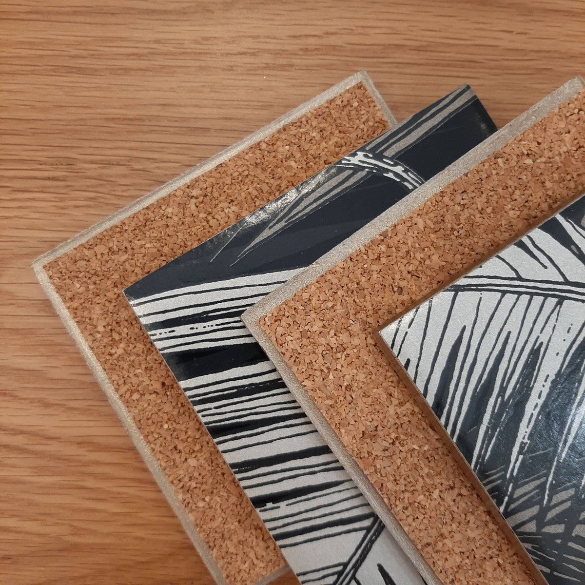 Reverse of Palm Jungle ceramic coasters showing cork backing and metallic edging.