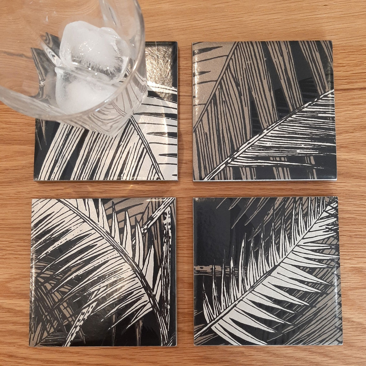 One-of-a-kind set of four ceramic coasters handmade using Cole & Son Palm Jungle wallpaper.