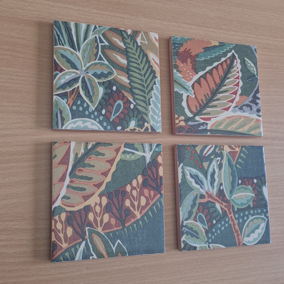 Video of one-of-a-kind set of four handmade Nature's Exhibitionists ceramic coasters showing the colourful wildlife and maximalist botanical design.

