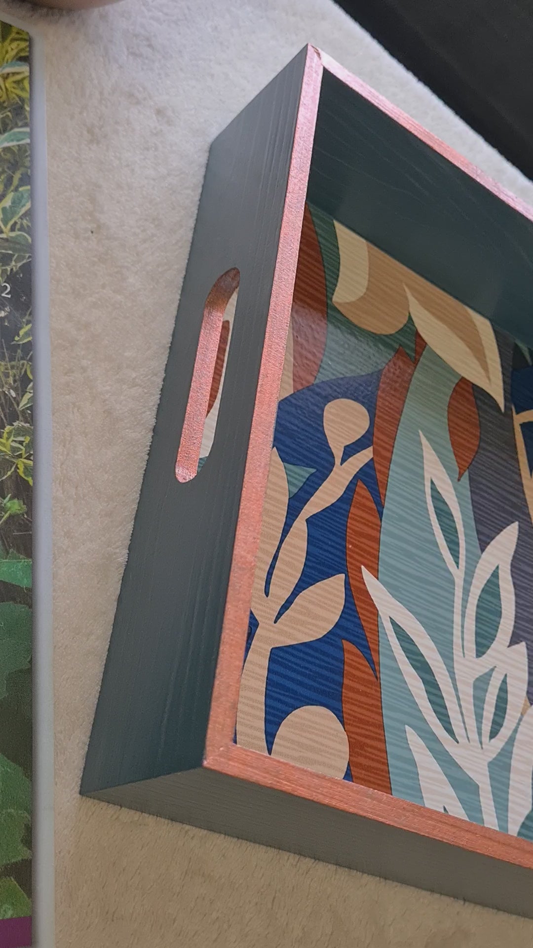 Video of Handcrafted deep teal wooden serving tray decorated with a bold retro leaf design and metallic copper edging.