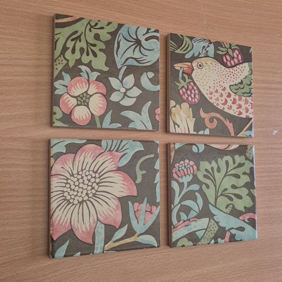 Handmade William Morris Strawberry Thief ceramic coasters showing the Chocolate Brown colourway and their individual handcrafted finish, edging and backing.

