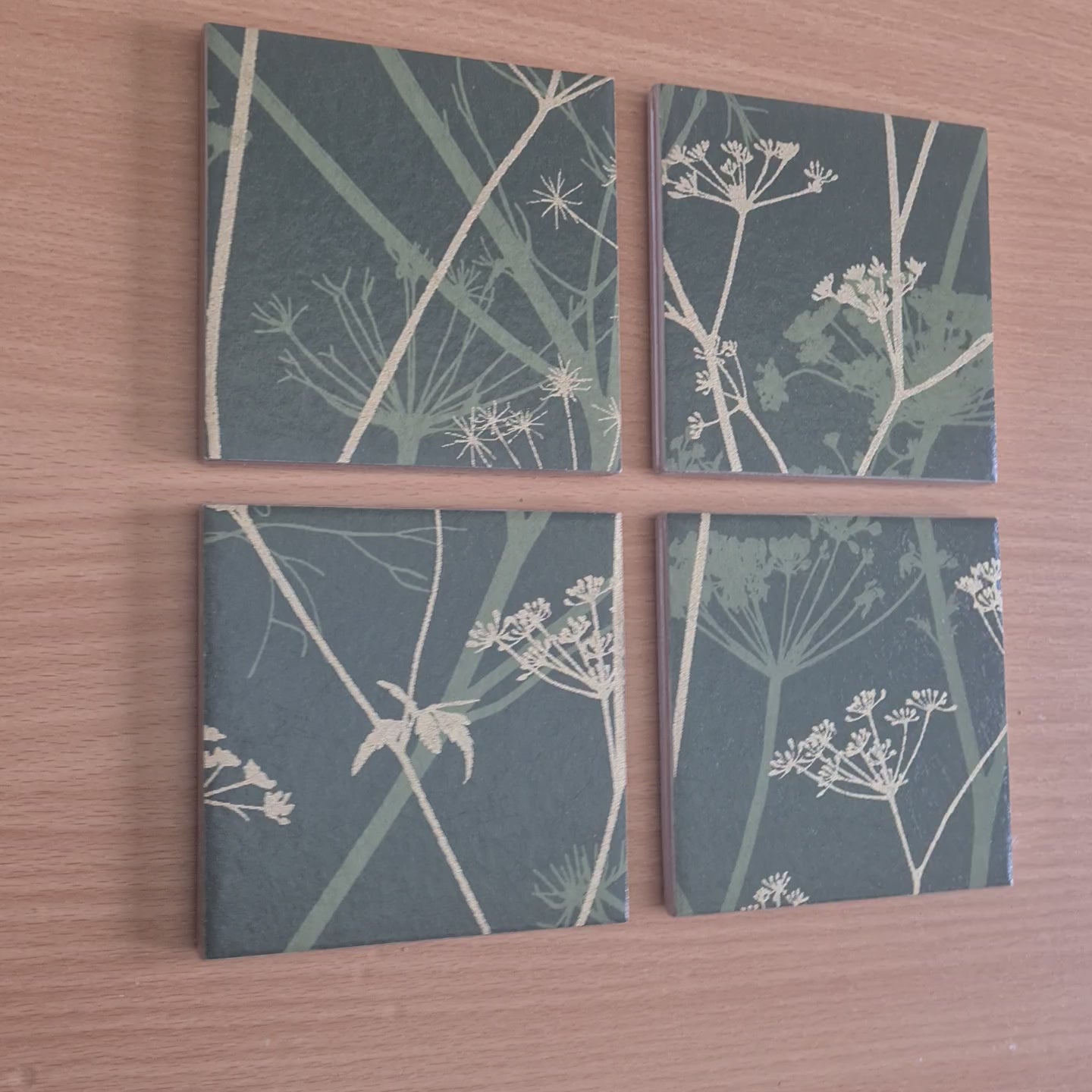 Limited-edition ceramic coasters handmade using Clarissa Hulse Wild Chervil wallpaper, showing the Sage and Gold botanical design and individual handcrafted finish.

