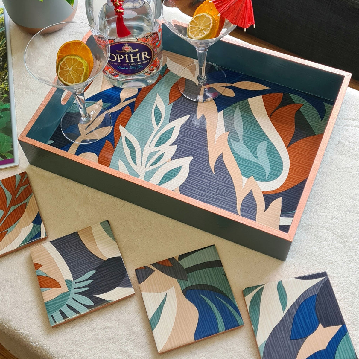 Limited-edition set of four handmade Retro Leaf ceramic coasters in teal, burnt orange, blue, beige and cream with matching serving tray, available separately.