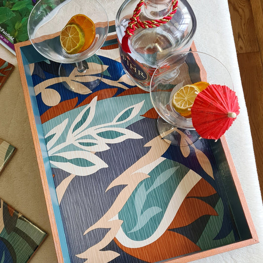 Colourful Retro Leaf serving tray styled as a statement piece on a coffee table with cocktails.