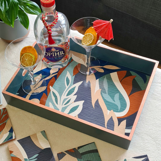 Handcrafted deep teal wooden serving tray decorated with a bold retro leaf design and metallic copper edging.