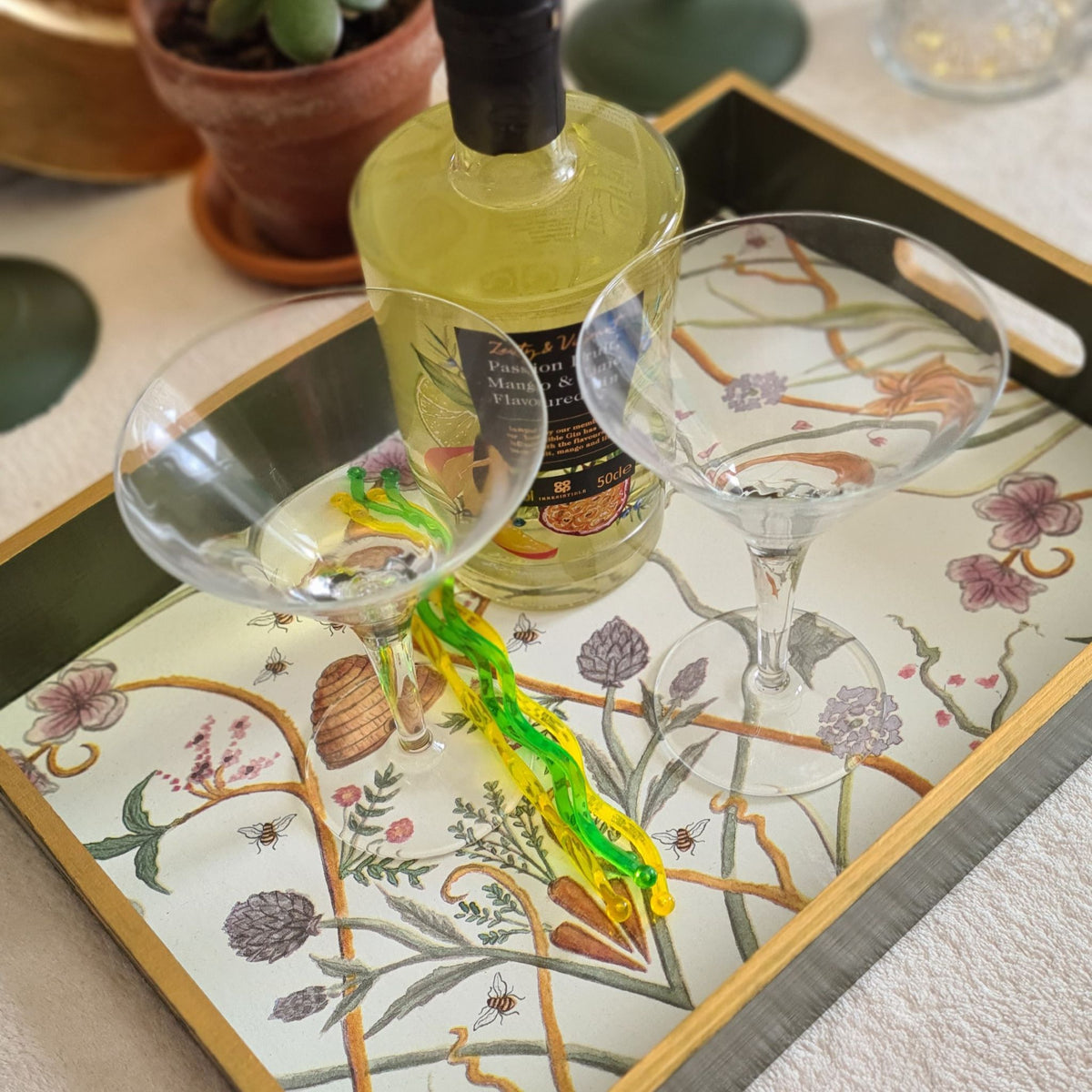 The Chateau Potagerie serving tray styled on a coffee table with flowers and coordinating home accessories.